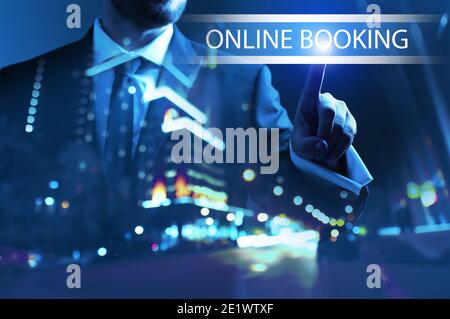 Businessman using virtual screen for online booking at night Stock Photo