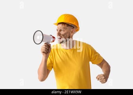 Protesting miner man with megaphone on light background Stock Photo