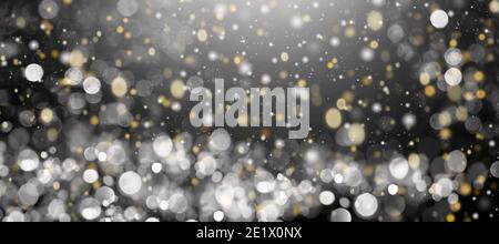 Defocused yellow and white lights on a black background. Gold and white bokeh. Stock Photo