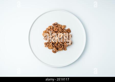 Walnuts peeled on a white background. The view from the top. Stock Photo