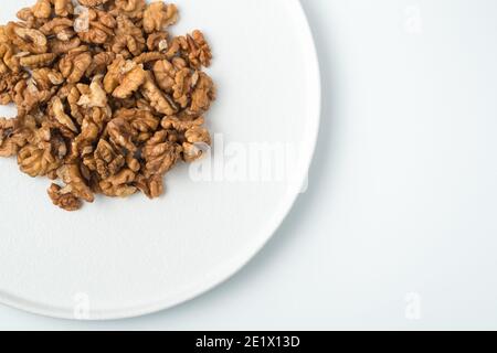 Peeled walnuts on a white background. The view from the top. Stock Photo