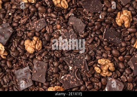 Walnuts, chocolate and coffee beans, background. The view from the top. Stock Photo