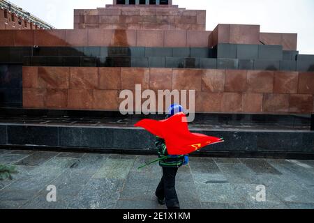 Moscow, Russia. 21st of December, 2020 A little boy holds the flag of the Soviet Union at the foot of the Vladimir Lenin mausoleum on Red Square during the laying of flowers by Communists at the grave of Joseph Stalin in Moscow, Russia Stock Photo