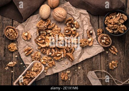 Culinary background with walnuts on a wooden background. The view from the top. Stock Photo