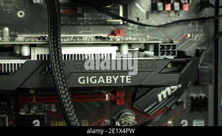 Moscow, Russia - 5 December 2020: Geforce GTX Gigabyte GPU graphic card in PCI Express of motherboard, Illustrative Editorial. Stock Photo