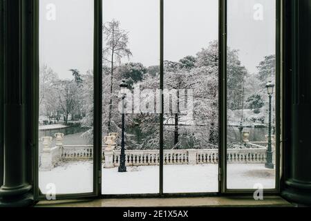 Madrid, Spain - January 2021: view from Glass Palace (Palacio de Cristal) in Retiro Park in Madrid with snow due to Filomena Storm. View from the insi Stock Photo