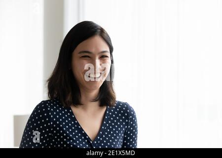 Happy emotional millennial mixed race korean asian woman laughing. Stock Photo