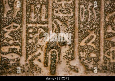 Shallow depth of field (selective focus) and close up footage with Egyptian hieroglyphs on a historic replica. Stock Photo