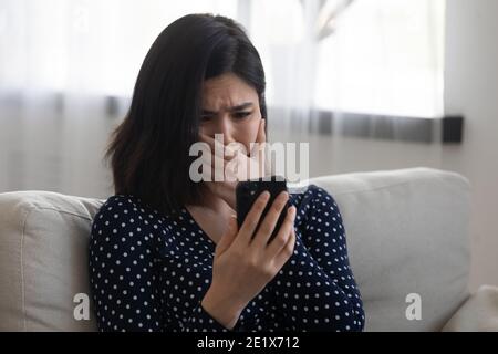 Stressed young korean asian woman getting email with bad news. Stock Photo