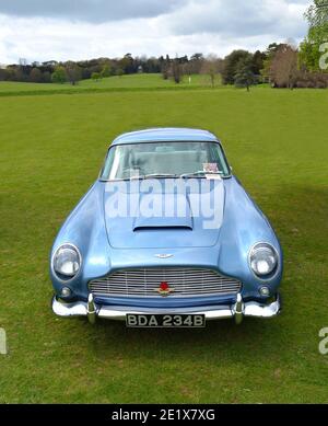 Classic Light Blue Aston Martin DB5 sports car parked on grass. Stock Photo