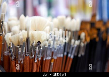 Group artistic paintbrushes for artist New paint brushes on shelf display in stationery shop. Art painting concept. Concept selling tools for artists