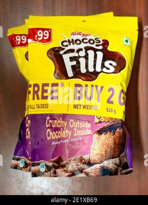 Packets of Kellogg's Chocos Fills, a crunchy-cereal with a chocolaty inside, on a wooden background. Stock Photo