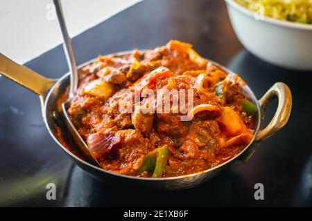 Kadai Mushroom is a dish made of sautéed button mushrooms, onions, bell peppers in a spicy, tangy tomato gravy. Stock Photo