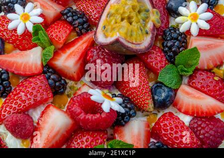 Anna Pavlova French dessert with blueberries, passion fruit, raspberries, strawberries. Meringue cake. Vegetarian cake. Low fat dessert. Stock Photo