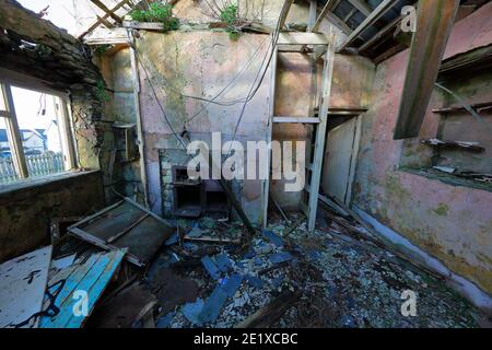 An old long since abandoned farm house in a terrible state of decay . Stock Photo