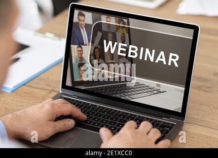 Unrecognizable man having webinar on laptop while working in office Stock Photo