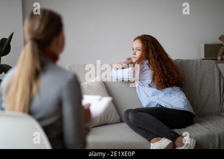 Child Psychologist. Worried sad teen girl at consultation Stock Photo