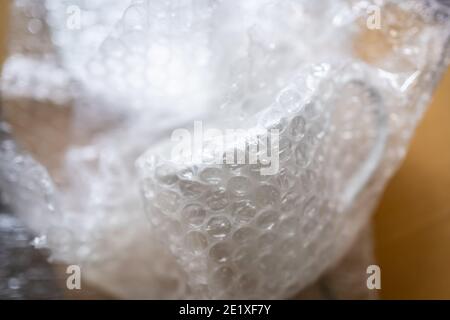 Wrapping a ceramic cup with bubble wrap Stock Photo