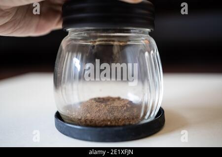 Grinding coffee beans with manual grinder Stock Photo