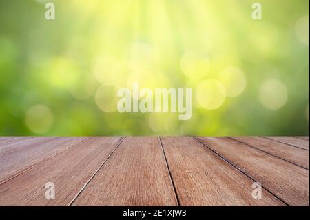 natural green background with selective focus. The green background has a bokeh leaf and grass on a white wooden floor. Stock Photo