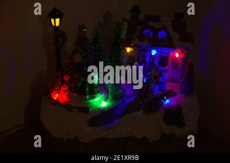 The representation of a Santa Claus Village. With colored lights and ...
