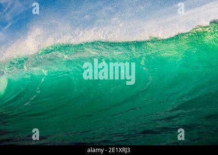 Perfect surfing wave in ocean. Breaking turquoise wave with sun light Stock Photo