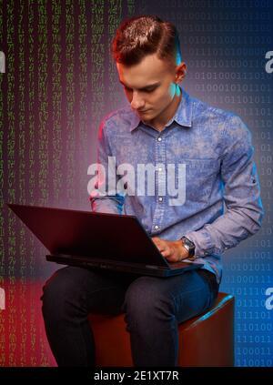 Young software developer working on his laptop Stock Photo