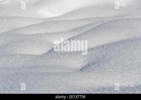 Gentle soft snowdrifts on frosty day. Winter landscape with snow covered field Stock Photo
