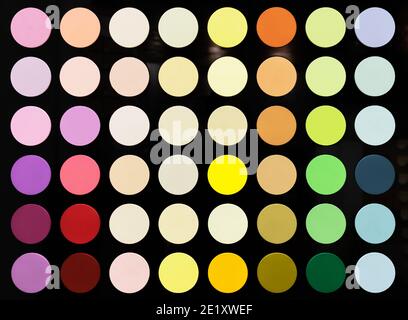 Multicolored circles on a black background. The palette of interior paints. Stock Photo