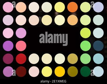 Multicolored circles on a black background. The palette of interior paints. Stock Photo