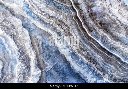Black quartz stone with white and gray stripes. Natural quartz background and texture. Stock Photo