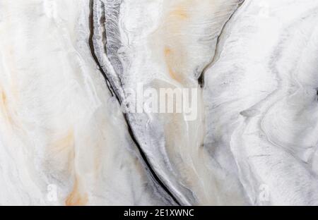 Gray natural marble with white and yellow stripes. Marble background. Stock Photo