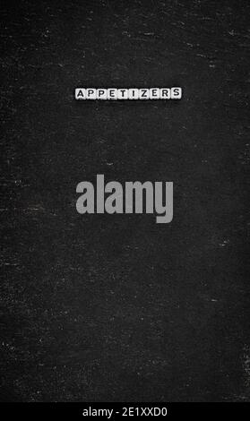 Word appetizers on black stone background Stock Photo