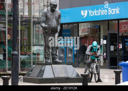 Bolton, UK - September 24 2020: A delivery driver stops next to the statue of Fred Dibnah in Bolton town centre on Thursday. Stock Photo