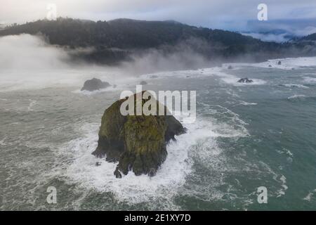 The Pacific Ocean washes against rugged sea stacks found just off the scenic coast of Northern California in Klamath. Stock Photo