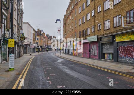 Covid-19: Boarded up shops on a closed and deserted Petticoat Lane Sunday market during the UK nationwide Lockdown.Wentworth Street, London,10th Jan21 Stock Photo