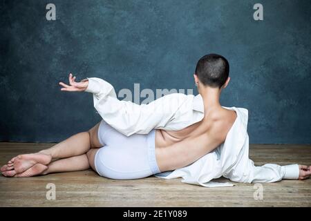 Non binary, gender neutral, biological female with shaved head, dances