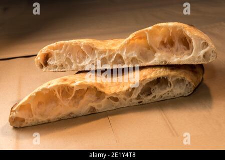Baked focaccia - bread of sourdough - Close up of cut loaf showing the alveoli as test of gluten strengthe Stock Photo