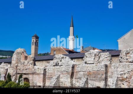 Historical Taslihan ruins with the old watch tower and minaret of Gazi Husrev mosque at the background, Sarajevo, Bosnia and Herzegovina Stock Photo