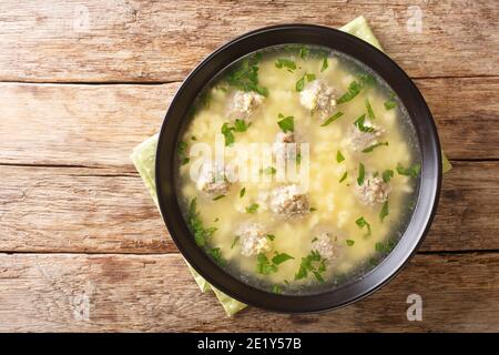 Sciusceddu is a traditional Sicilian dish, made with small meatballs simmered in broth, topped with a mixture of eggs, ricotta, and caciocavallo close Stock Photo