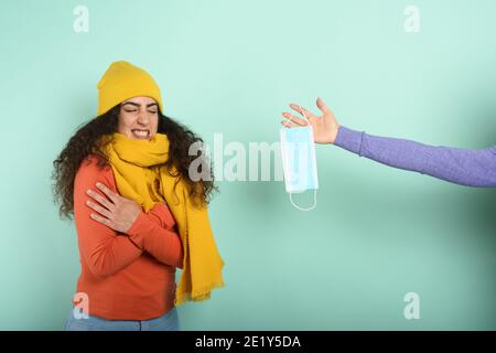 Girl caught a cold and someone give her a mask. Violet background Stock Photo