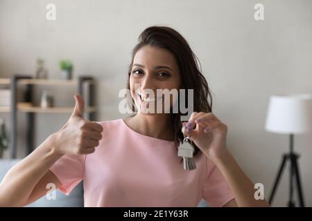 Portrait of smiling ethnic woman celebrate relocation Stock Photo