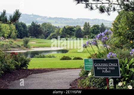 Golfers only beyond this point -sign in front of a golf course with water hazard in Dublin, Ireland Stock Photo