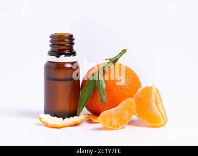 isolate, glass vial with pipette and tangerine on white background Stock Photo
