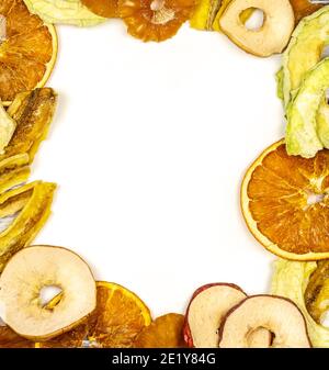 Frame of fruit chips. Healthy and fashionable snack. Trendy eats. Dried slices of orange, apple, pineapple, peach and banana with space for writing. S Stock Photo