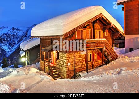 A picturesque chalet in Swiss Alps at night under abundant snow. This particular village is Bettmeralp in the Canton of Valais (Wallis), Switzerland. Stock Photo