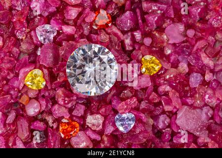 The diamonds are placed in an enclave of heart shaped diamonds on natural red garnet tumbled stone. jewelry in heart shape are lovely present for vale Stock Photo