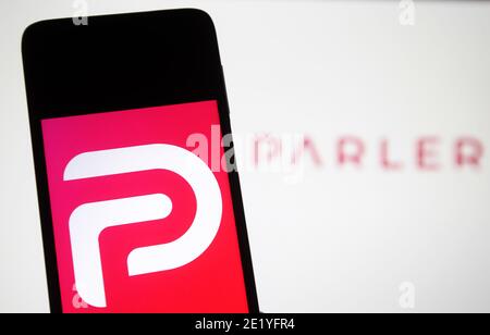 In this photo illustration the Parler logo seen displayed on a smartphone.Google, Apple and Amazon have suspended the social networking app Parler. Parler became unavailable in App Store, Google Play and Amazon Web Services, reportedly as said insufficient control over user posts that encouraged violence, reportedly by media. Stock Photo