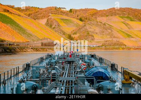 Binnenvaart, Translation Inlandshipping on the river rhein in Germany during sunset hours, Gas tanker vessel rhine river oil and gas transport Germany near Koblenz Stock Photo