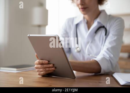 Young female general practitioner using digital computer tablet. Stock Photo